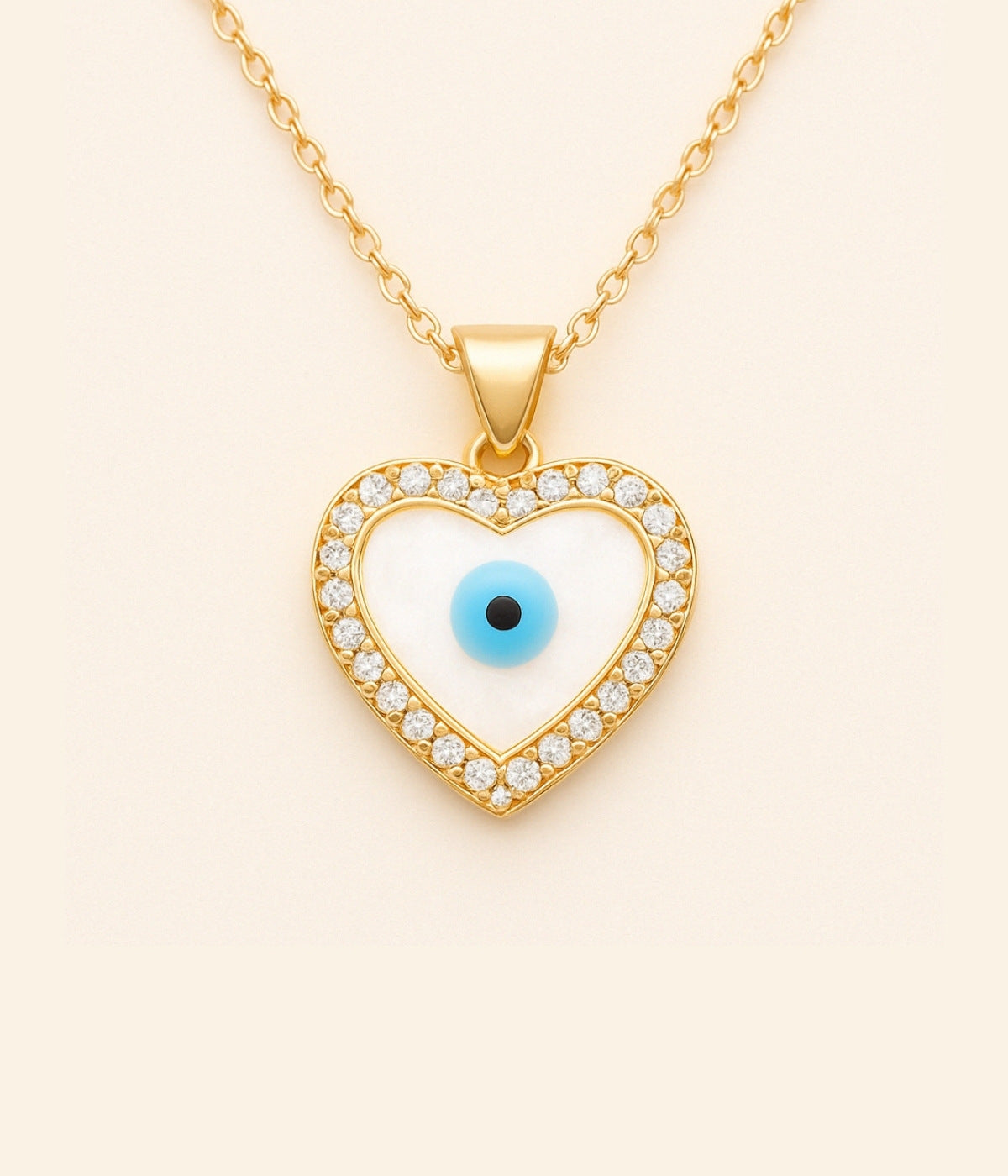 Goldene Kette mit Herzanhänger und blauem Auge – türkisches Auge als Schutzsymbol