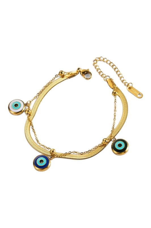 Armband mit drei blauen Augen in Gold vor weißem Hintergrund 